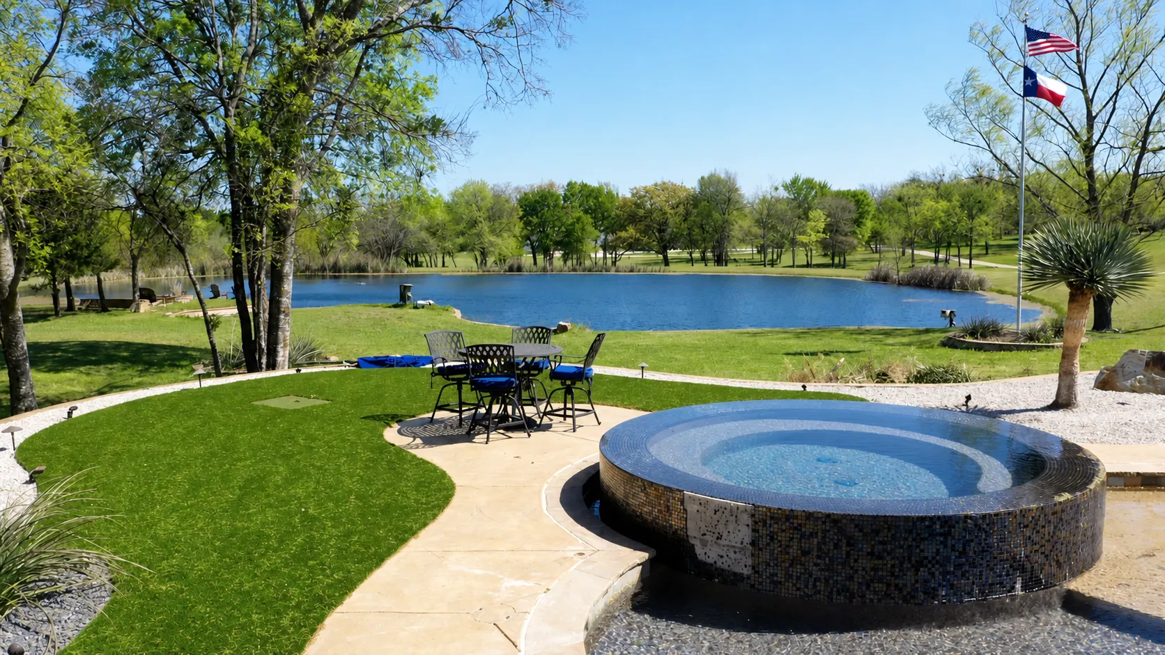 Texas estate with turf, spa, and pond with flag