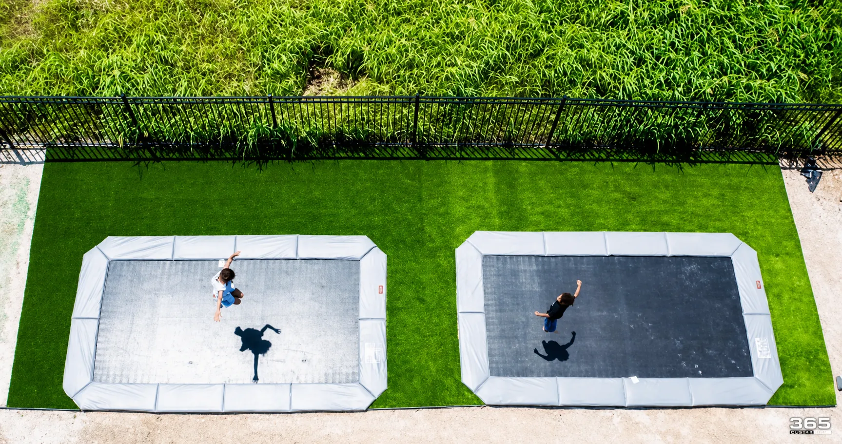 Kids jumping on trampolines with turf